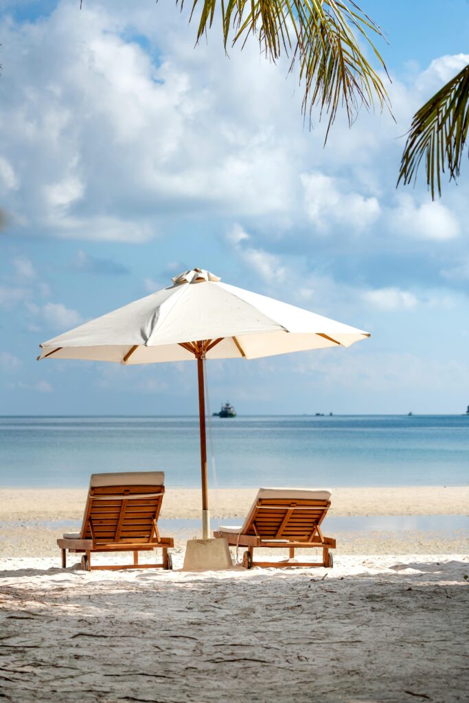 pexels-photo-3355732-3355732 Idyllic beach scene with chairs and umbrella, perfect for a serene vacation setting.