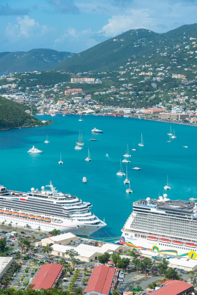 pexels-photo-3663899-3663899 Stunning aerial view of cruise ships docked in a tropical Caribbean harbor surrounded by turquoise waters.