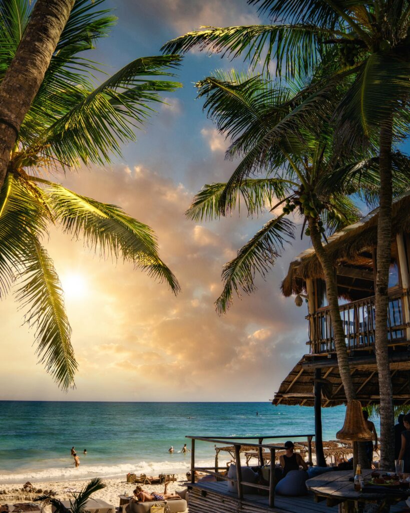 pexels-photo-3822155-3822155 Stunning sunset view at Tulum Beach, Mexico, showcasing coconut palms and tranquil ocean.