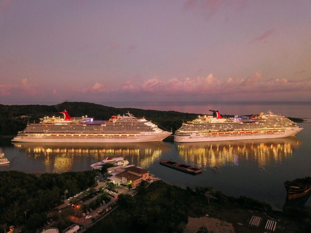 pexels-photo-2678418-2678418 Two illuminated cruise ships docked at Coxen Hole, Honduras during twilight.